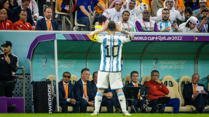 Argentina’s Lionel Messi celebrates in front of the Netherlands’ bench after a World Cup win.